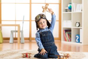 child_plays_motor_skills_wooden_toys_merle_toys